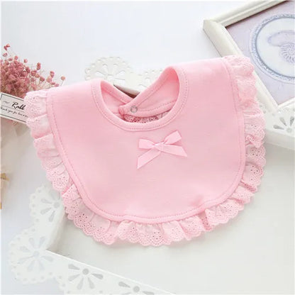 Three girls' cotton lace feeding bibs laid out, displaying different stylish lace patterns and soft material.