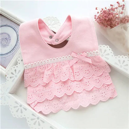Detailed view of the snap closure on a cotton lace baby bib, designed for easy and secure fastening.