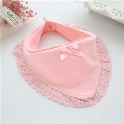 Newborn girl asleep, wearing a white cotton lace baby bib, ensuring comfort and drool protection.