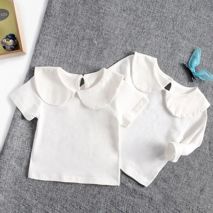 White cotton toddler shirt with a subtle design, children's apparel favorite