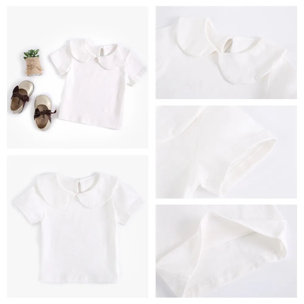 Group of assorted white cotton tops for infants and toddlers, baby boutique essentials