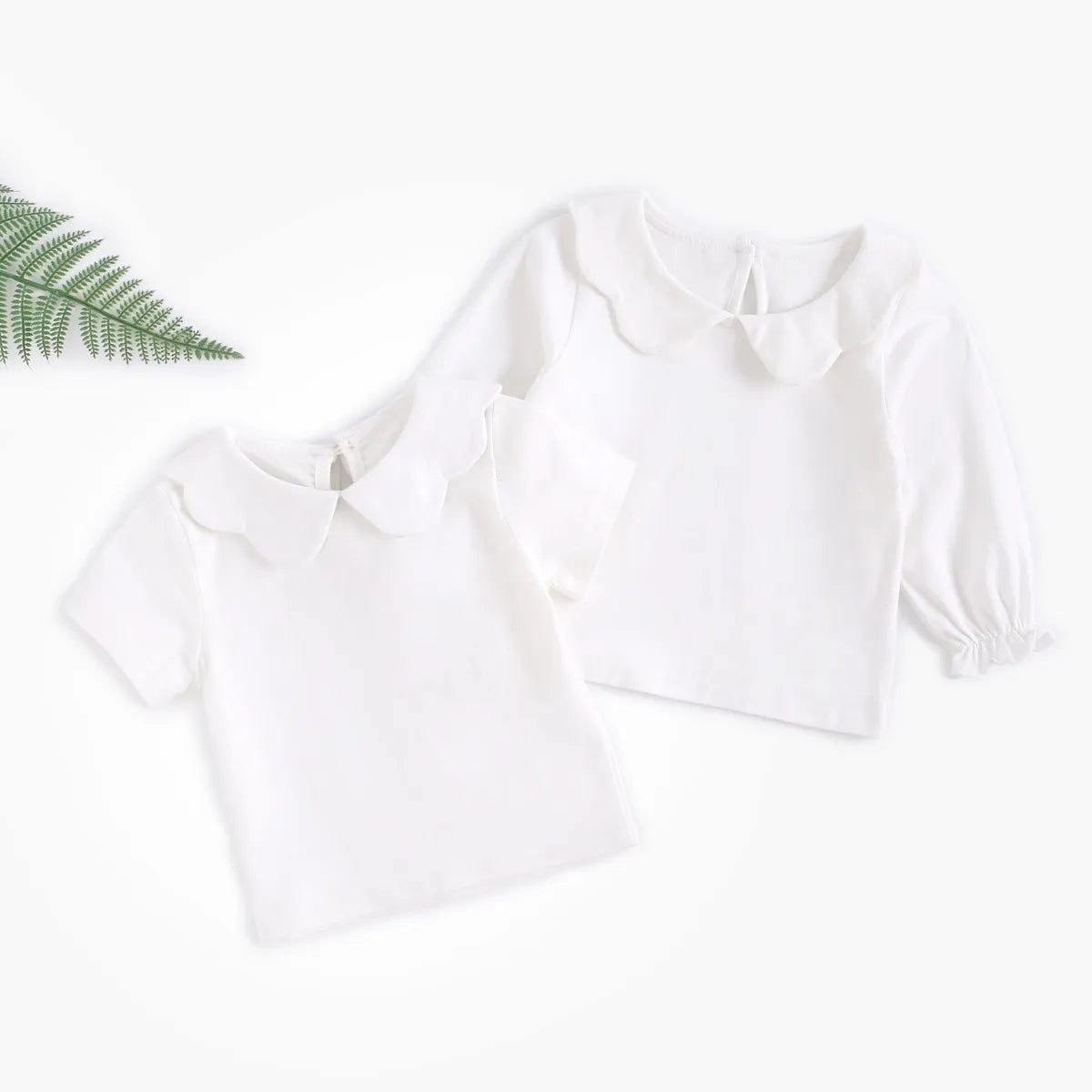 Baby girl in white cotton top with delicate detailing, perfect for spring summer outfit