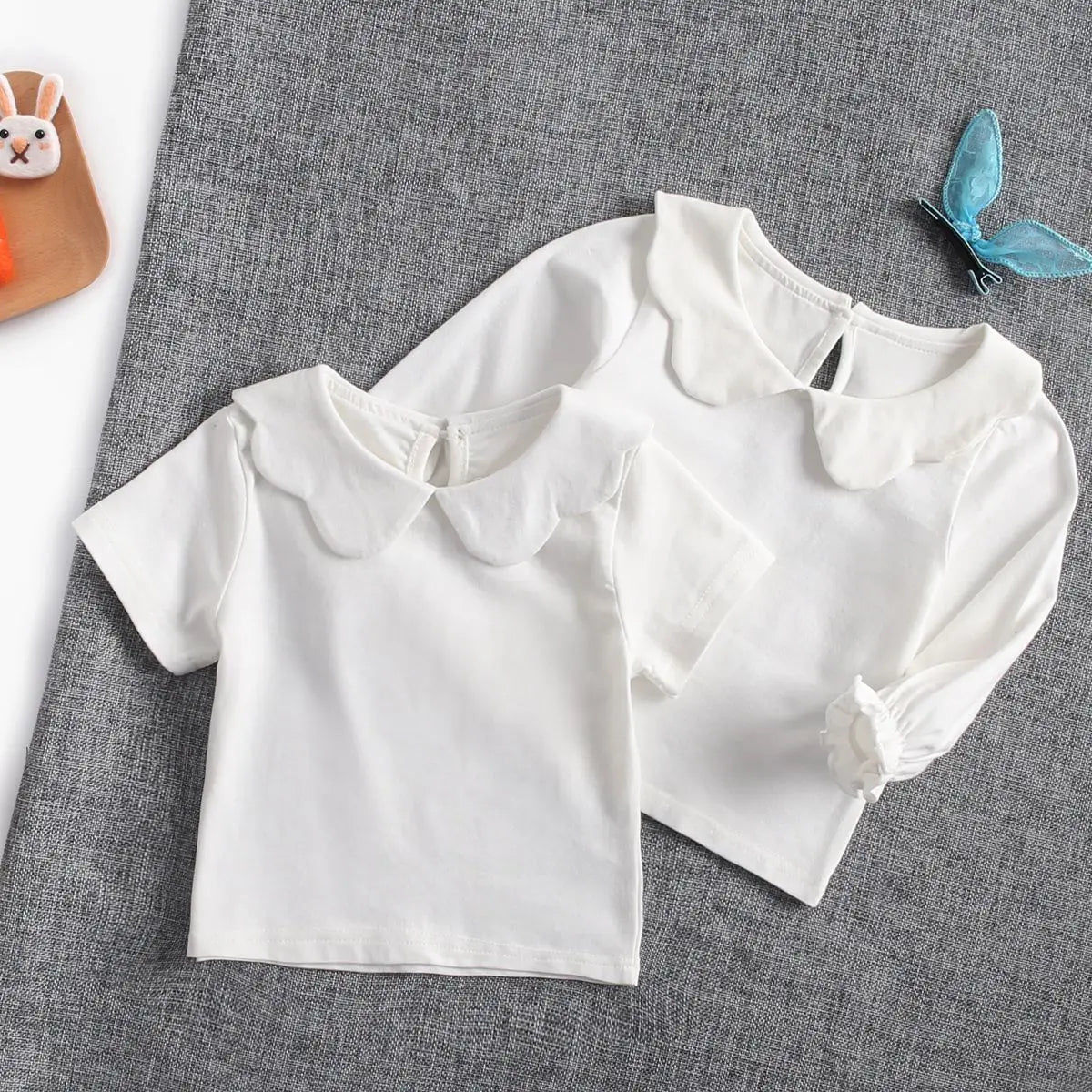 Toddler wearing a bright white cotton short sleeve top, comfortable infant fashion