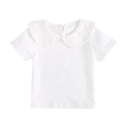 Detailed fabric texture of a white cotton fashion top for toddlers, soft and breathable