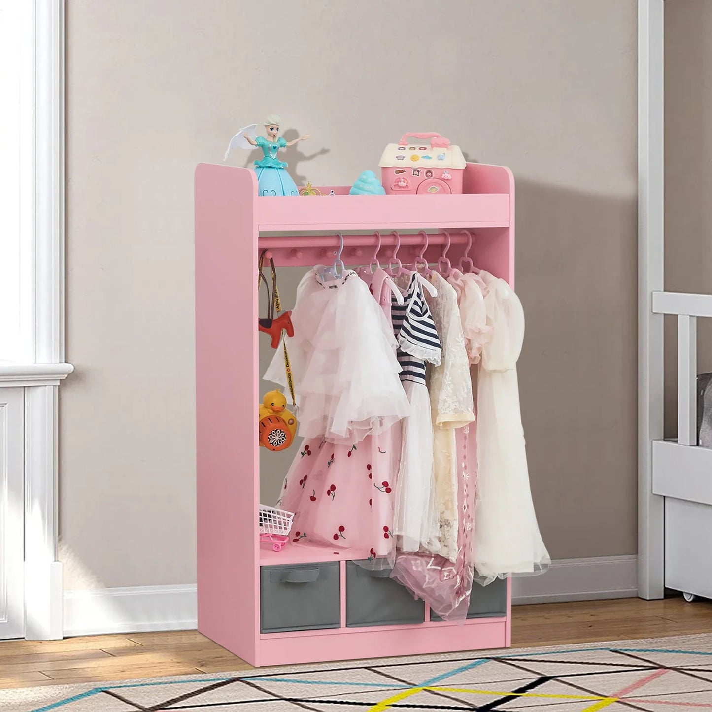 White kids dress-up closet with mirror, storage, and hangers for playroom organization