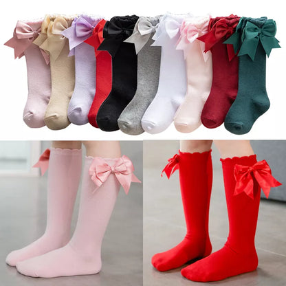 White knee-high socks for girls with large pink bow, soft cotton blend, for newborns.