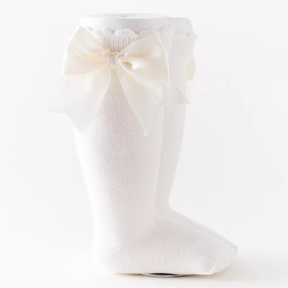Brown knee-high socks for girls with a rustic plaid bow, ideal for autumn fashion.