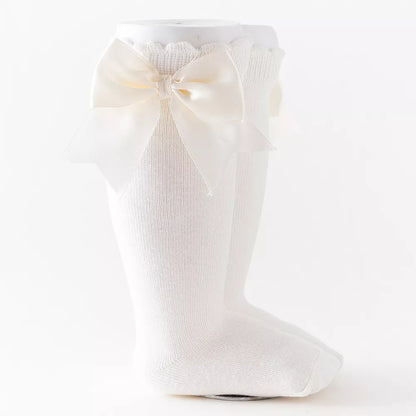 Brown knee-high socks for girls with a rustic plaid bow, ideal for autumn fashion.