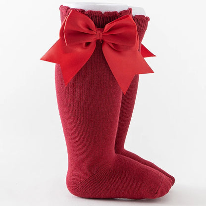 Maroon knee-high socks with a deep purple bow, sophisticated choice for baby fashion.
