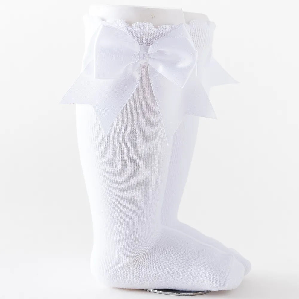 Purple knee-high socks with a grand pink bow, charming baby accessory for special occasions.