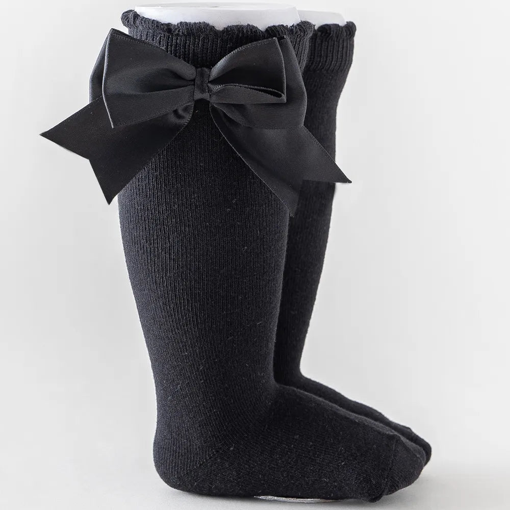Aqua blue knee-high socks for toddlers, cute large matching bow, comfortable kids fashion.