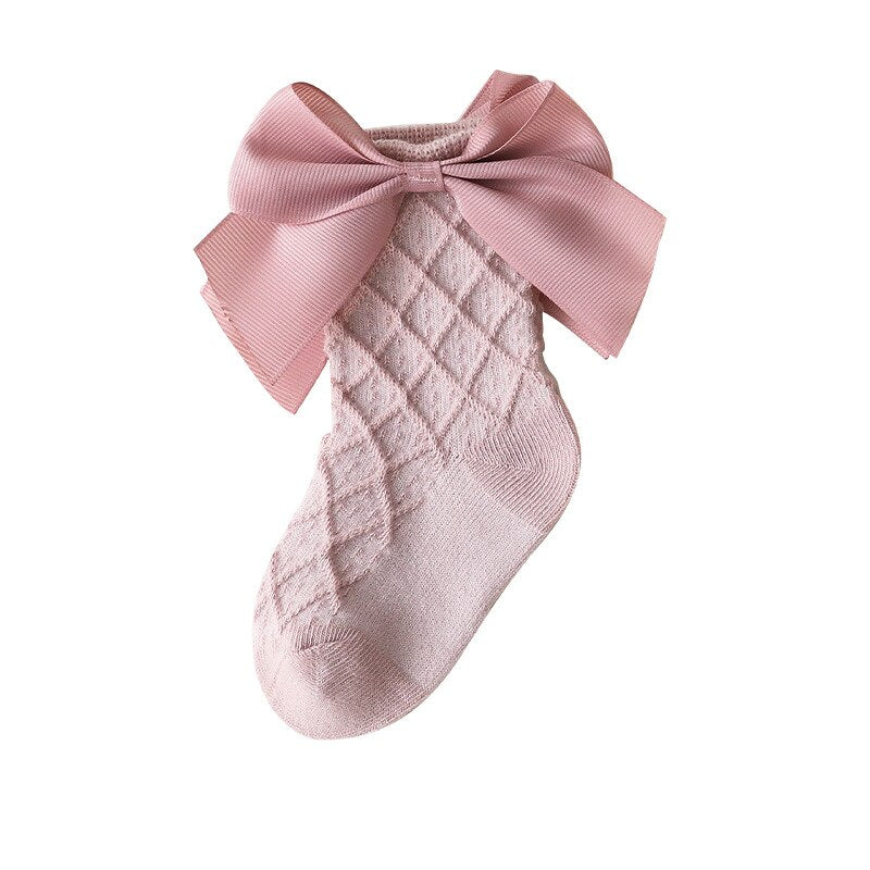 Folded pair of pink lace flower tube socks for kids, breathable cotton comfort