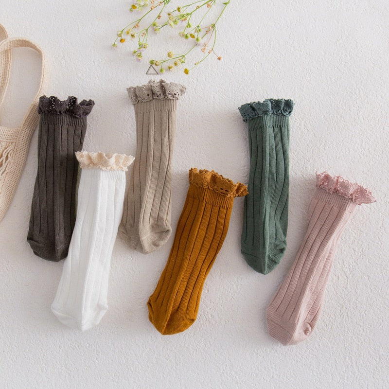 Zoomed view of the soft cotton fabric and delicate lace frill on girls' ankle socks, quality detail
