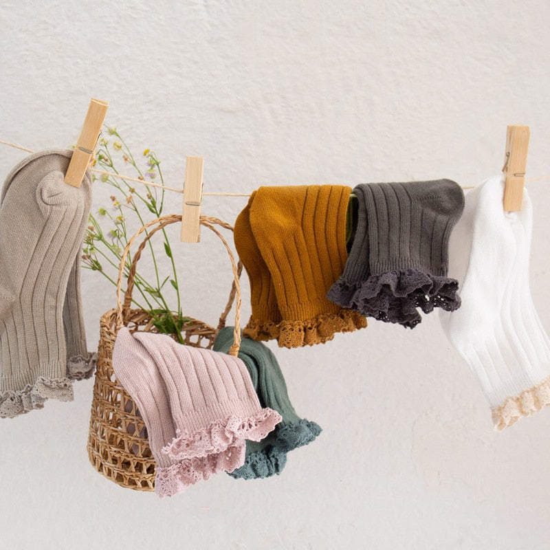 Girls' frilly ankle socks with elegant lace trim, made from soft cotton, available in multiple colors