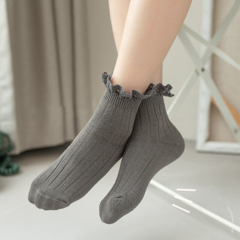 Cute girls' cotton ankle socks with white lace frills, perfect for dress-up or everyday wear
