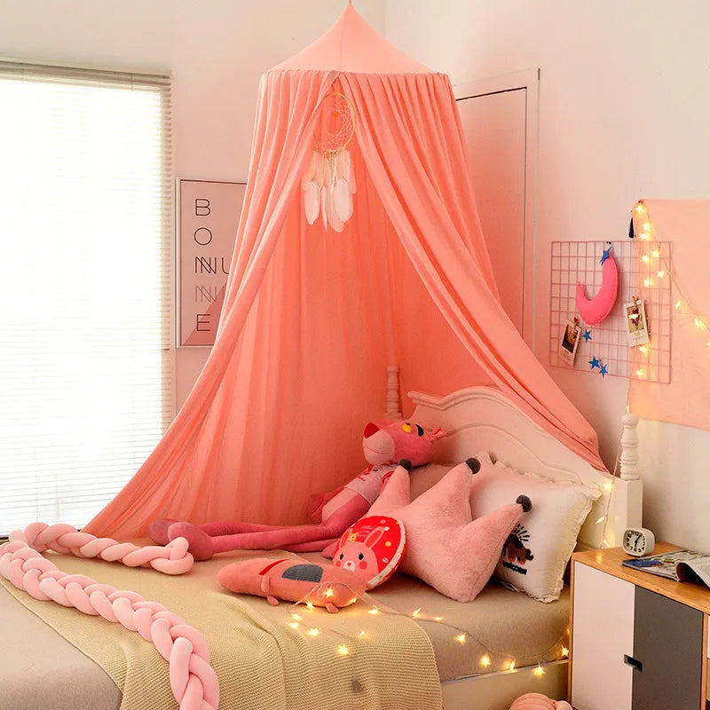 Unisex nursery decor: white bed canopy with mosquito net for a royal touch.