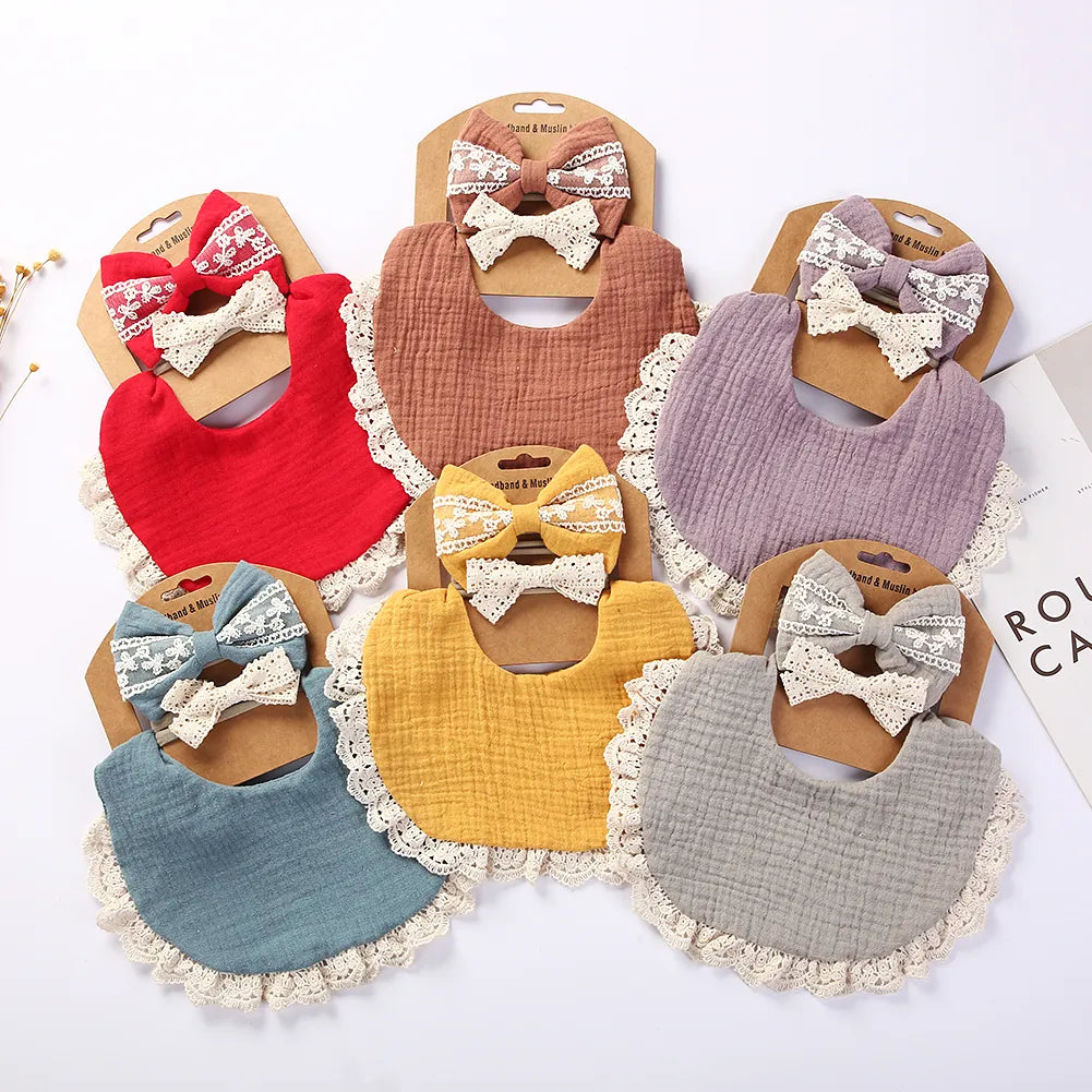 Soft white cotton baby bib with delicate lace trim paired with a matching lace headband for stylish infant accessory.