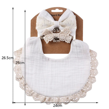 Close-up of a white muslin cotton baby bib, excellent for newborn feeding and dribble, with elegant lace detail.