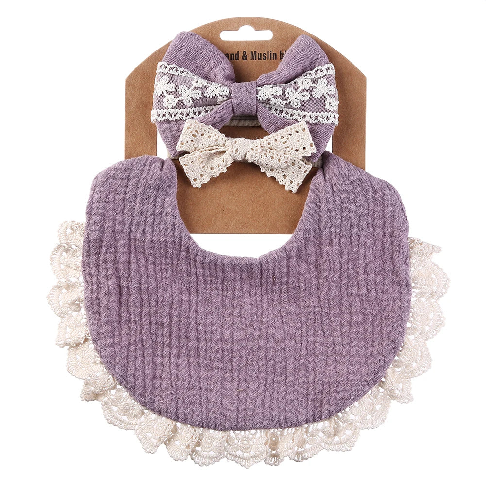 White cotton baby feeding bib and coordinating lace headband, essential baby shower gift for new parents.