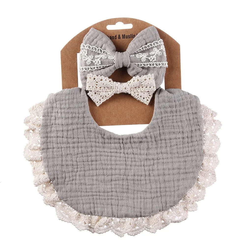 Infant nursing gift: white cotton baby bib and matching lace headband, designed for comfort and style.