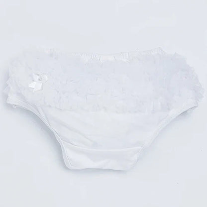 Toddler girl playing in a yellow ruffled diaper cover, durable cotton blend baby shorts