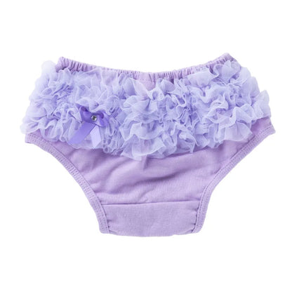 Close-up texture of a cotton blend ruffled diaper cover, soft infant essentials in white