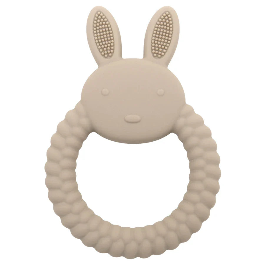 Child happily chewing on a blue silicone rabbit teether, comfortable and safe teething solution