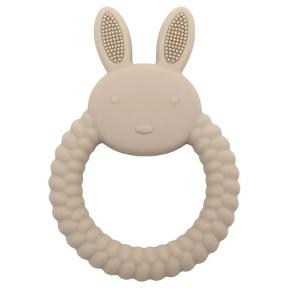 Child happily chewing on a blue silicone rabbit teether, comfortable and safe teething solution