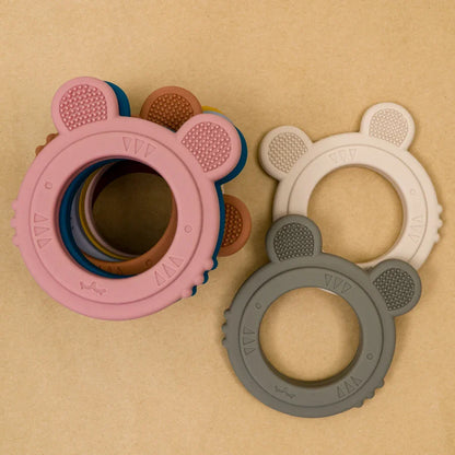 Newborn infant gently sucking on a mini silicone rabbit teether, safe and comforting