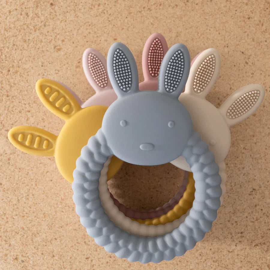 Pink silicone rabbit teether, gentle teething toy for infants, promotes oral development