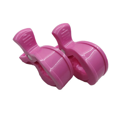 Practical pram pegs: two white clips for securing baby toys or blankets to stroller