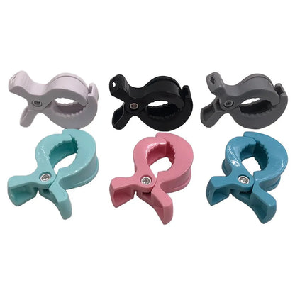 Baby travel accessory: two white stroller clip hooks for convenience and organization