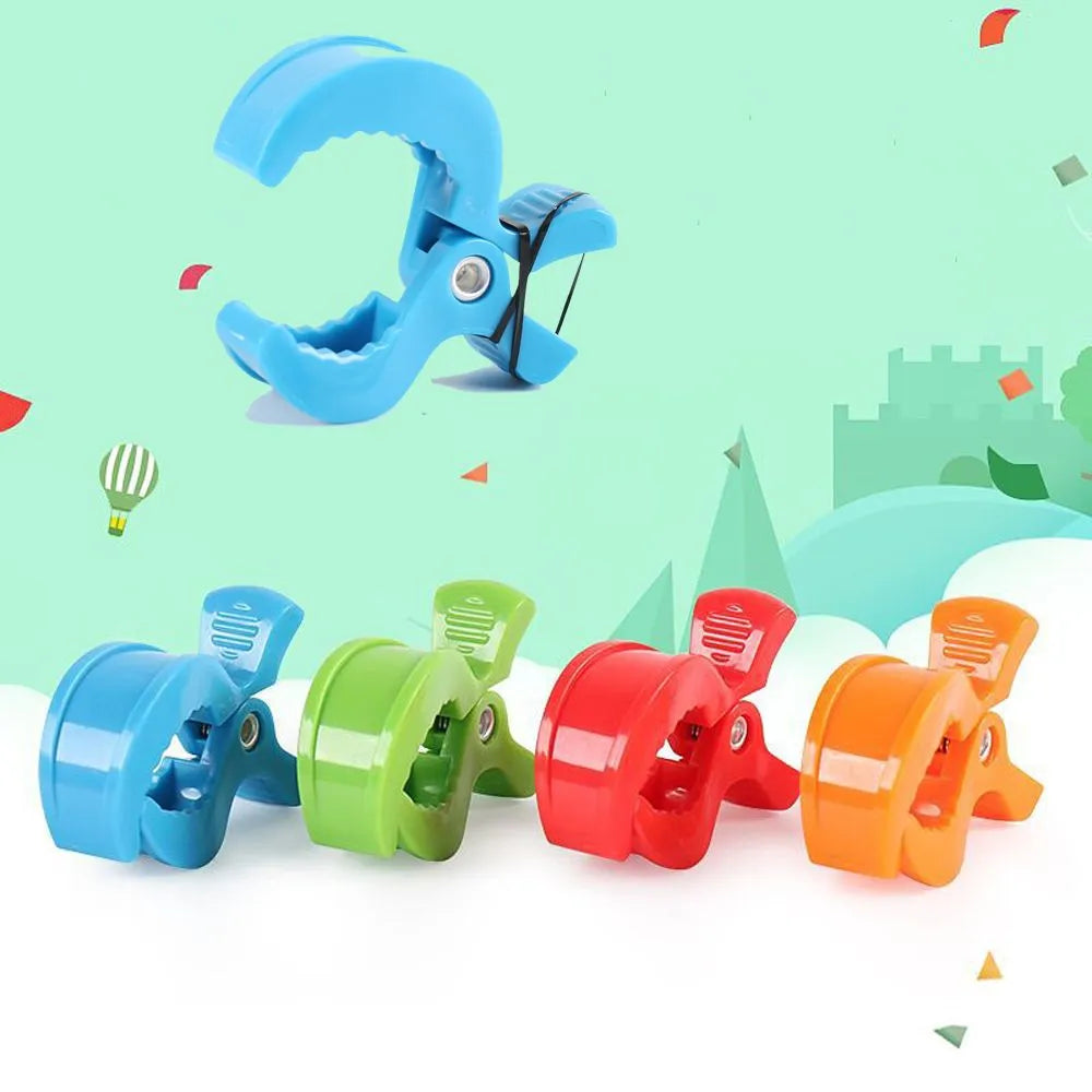Nursery accessory: pair of white stroller clips keeping blankets and toys secure