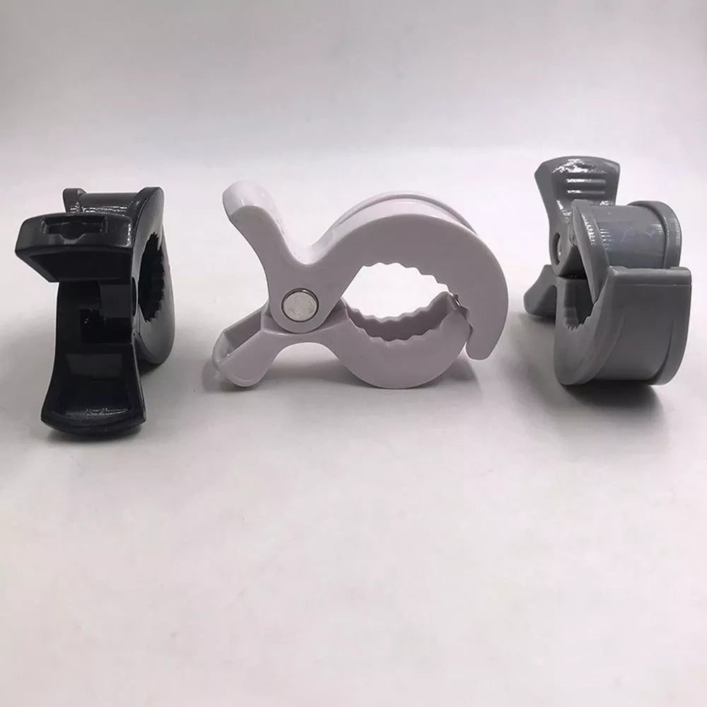 A pair of white universal stroller clips with strong spring for reliable securement