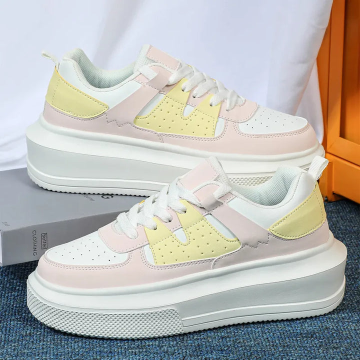 Modern women's platform sneakers, comfortable lace-up design with stylish perforated accents.