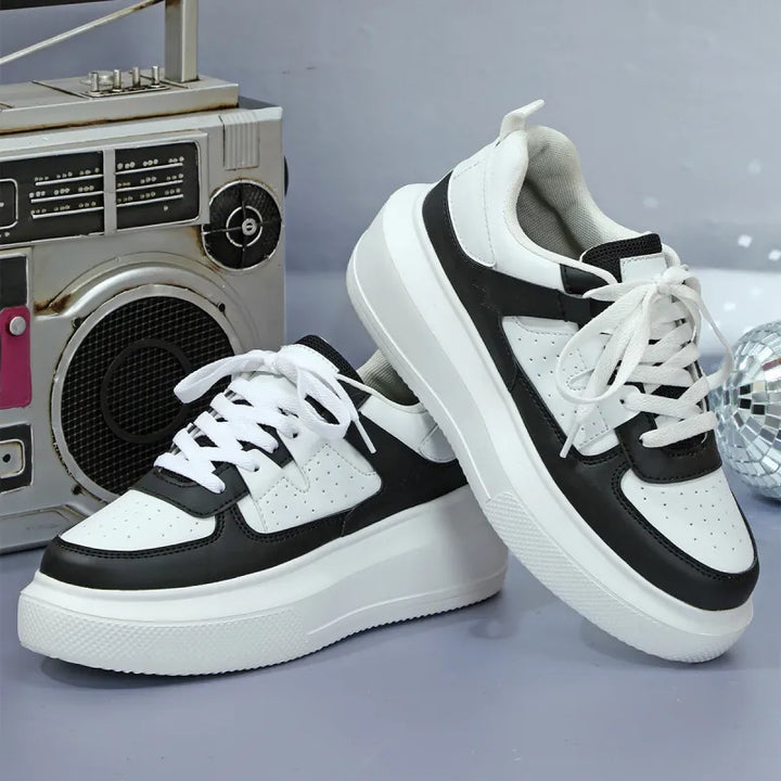 Versatile black women's platform sneakers, lace-up & perforated for casual or fashion outfits.