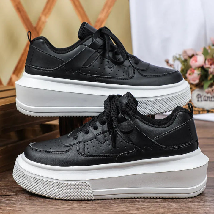Modern casual women's platform sneakers in white, featuring perforated sides and classic lace-up style.