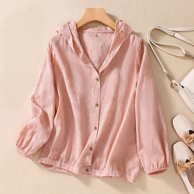 Comfortable pink women's hooded shirt with a relaxed fit, ideal for versatile layering.