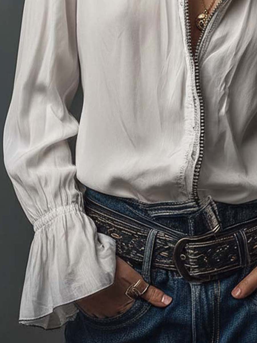 Fashionable white women's blouse, featuring a zip front, stand collar, and dramatic bell cuff sleeves.