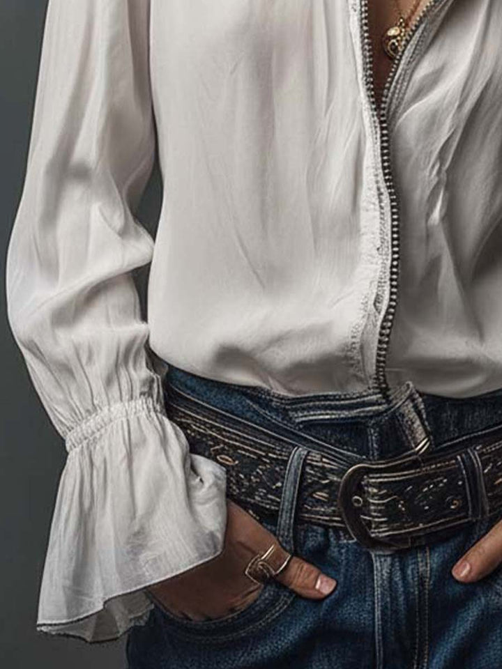 Fashionable white women's blouse, featuring a zip front, stand collar, and dramatic bell cuff sleeves.