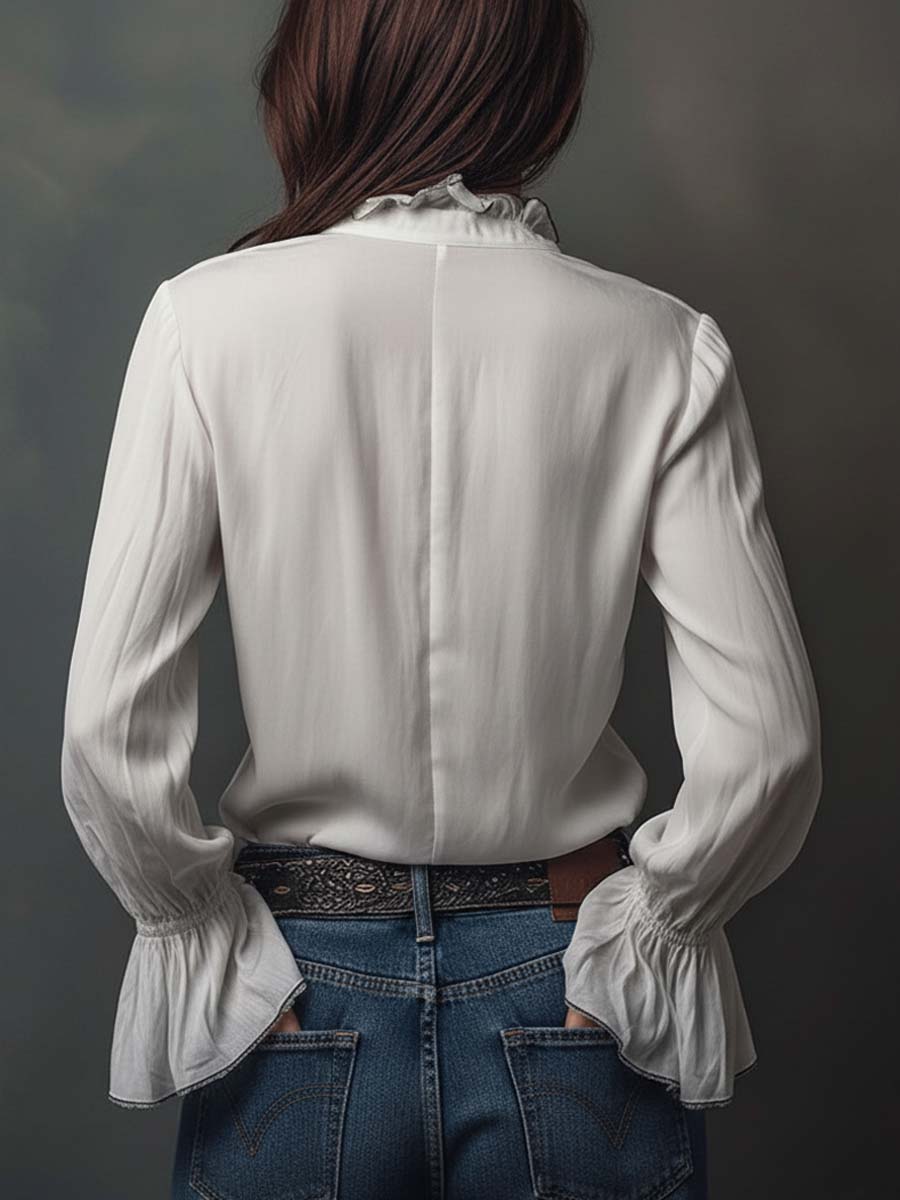 Stylish white long-sleeve blouse with a unique zip-front design & fashionable bell cuffs. Versatile women's top.