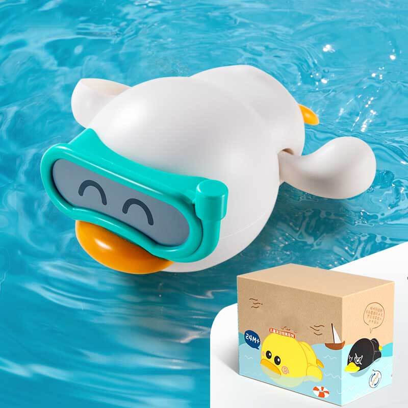 Happy child holding a new wind-up swimming duck bath toy