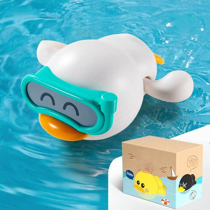 Happy child holding a new wind-up swimming duck bath toy