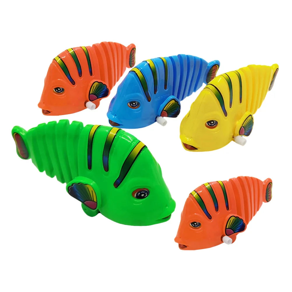 Kid's wind-up fish toy in red, wiggling on a table, a great stocking stuffer