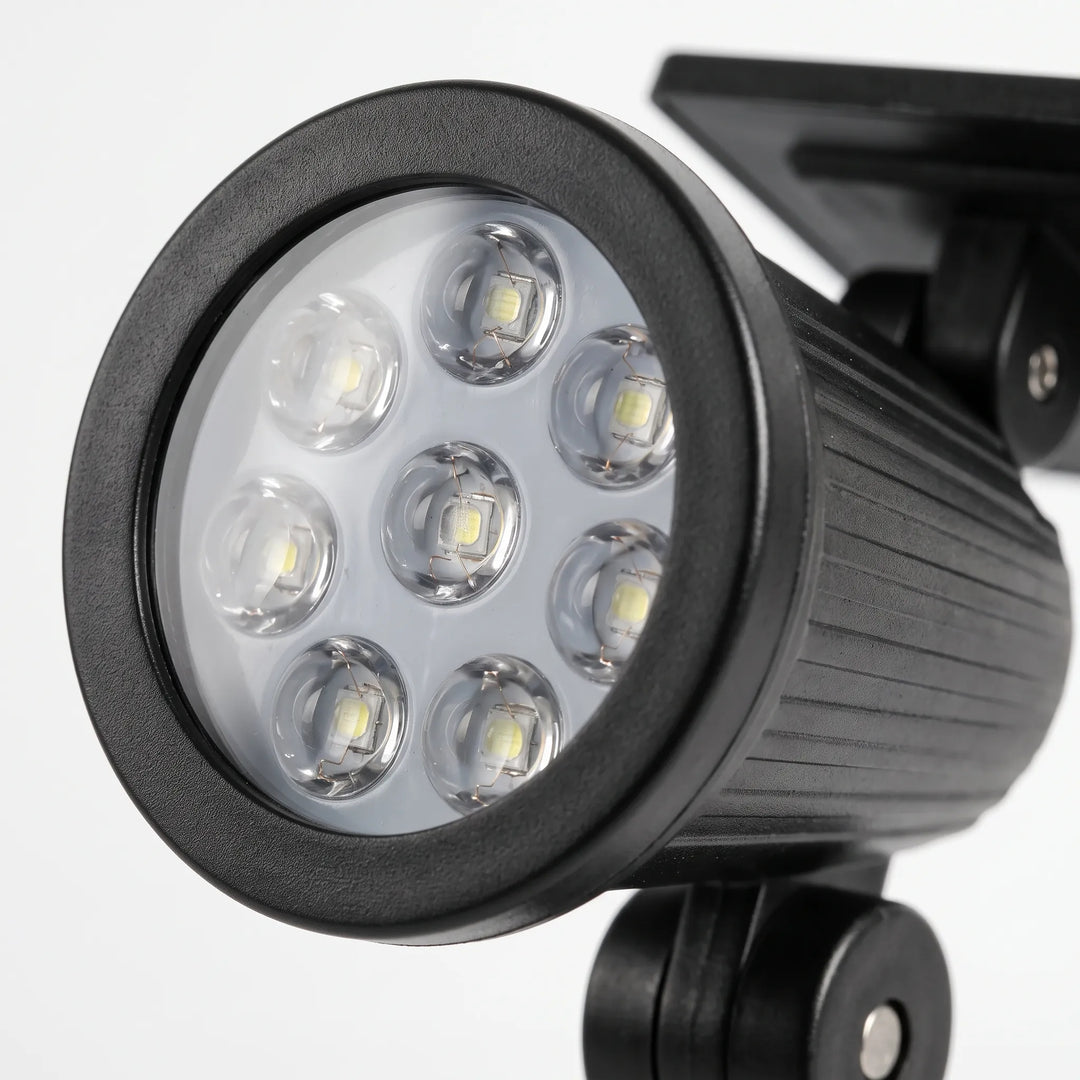 Wall-mounted wireless solar spotlight, adjustable for outdoor landscape light.