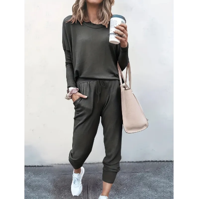 Woman modeling a cozy heather gray relaxed fit crew neck and jogger matching set for comfortable loungewear.