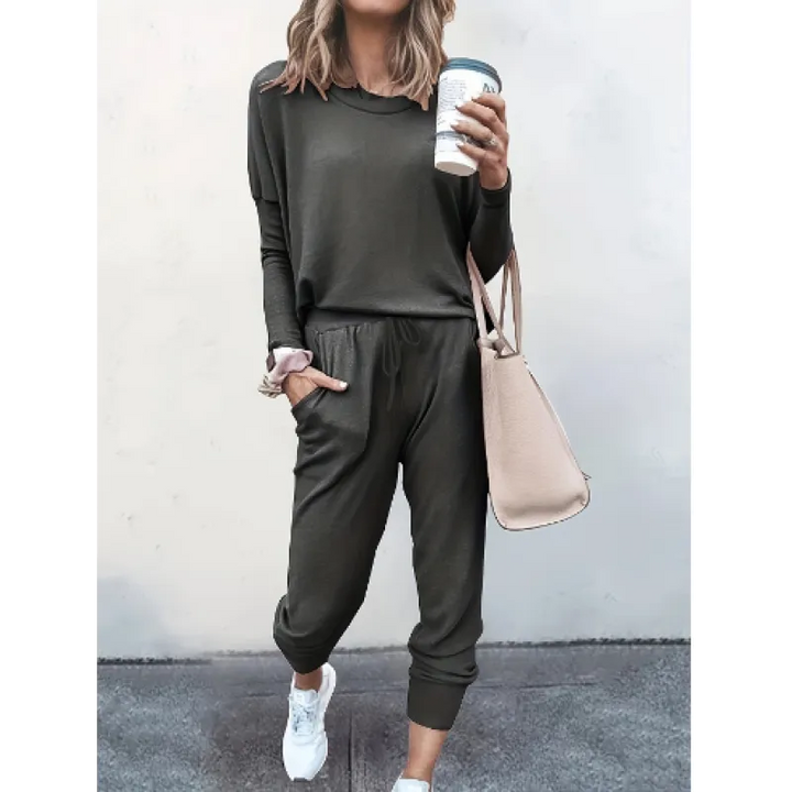 Woman modeling a cozy heather gray relaxed fit crew neck and jogger matching set for comfortable loungewear.