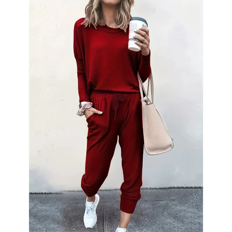 Woman relaxing at home in a stylish women's cozy crew neck and jogger matching set, perfect casual outfit.