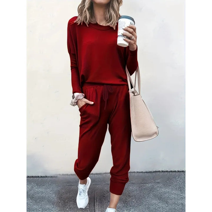 Woman relaxing at home in a stylish women's cozy crew neck and jogger matching set, perfect casual outfit.