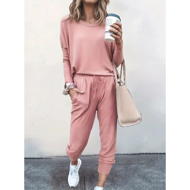 Back view of a woman in a relaxed fit women's cozy crew neck and jogger matching set, ideal for lounging.